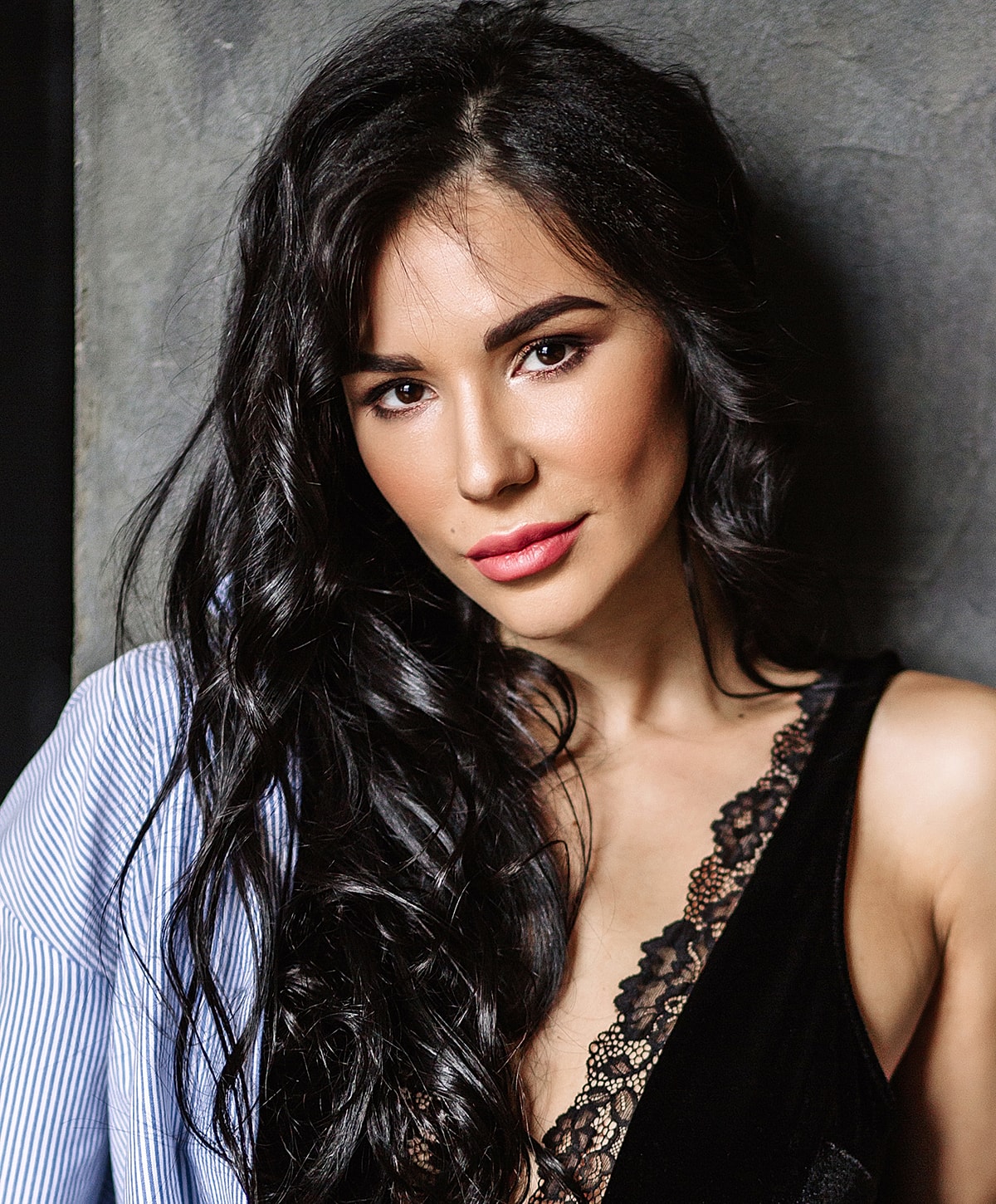 Woman with long hair in stylish outfit.
